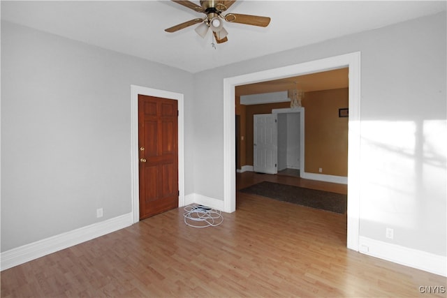 empty room with ceiling fan and light wood-type flooring