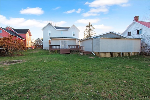 back of property featuring a lawn and a wooden deck