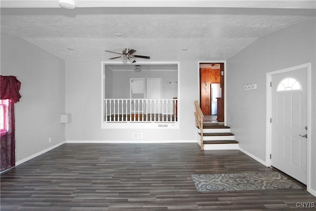 foyer entrance featuring dark hardwood / wood-style flooring, a textured ceiling, ceiling fan, and lofted ceiling