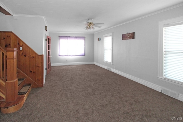 empty room with dark colored carpet, ceiling fan, and ornamental molding