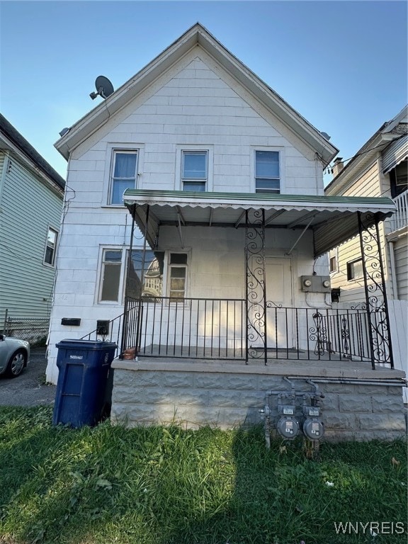 rear view of property with a porch