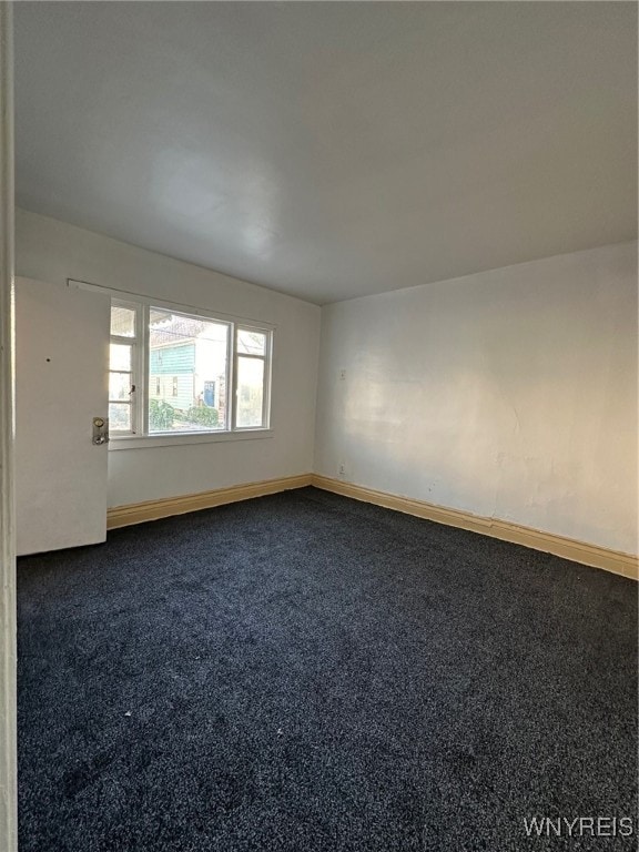 empty room featuring dark carpet