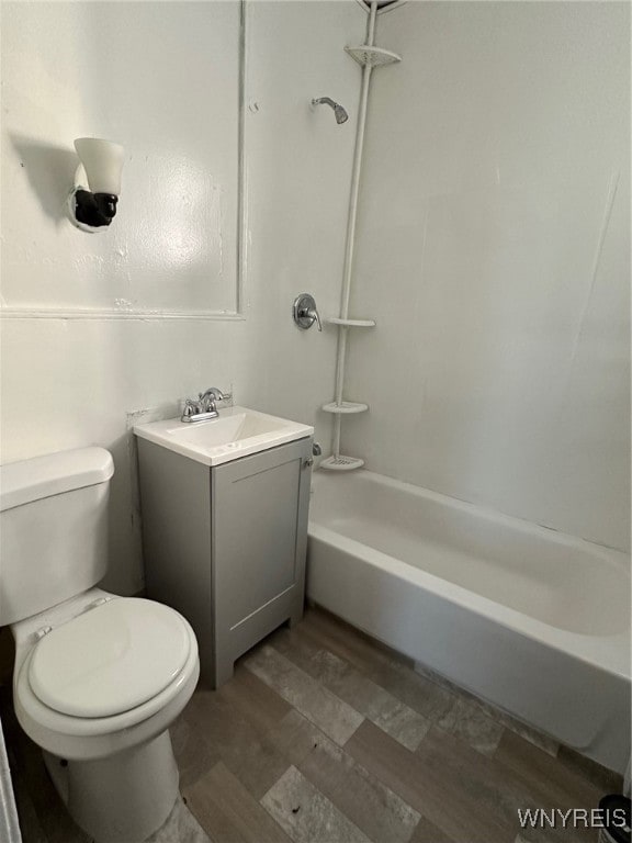 full bathroom with wood-type flooring, shower / bath combination, vanity, and toilet