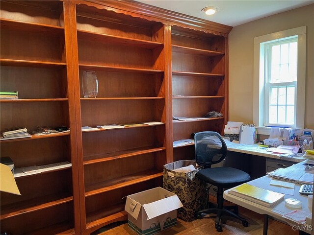 office featuring built in desk and hardwood / wood-style floors