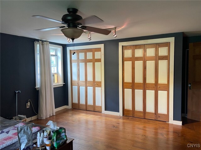 interior space featuring wood-type flooring and ceiling fan