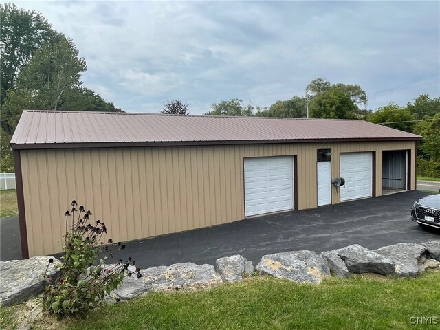 garage featuring wood walls