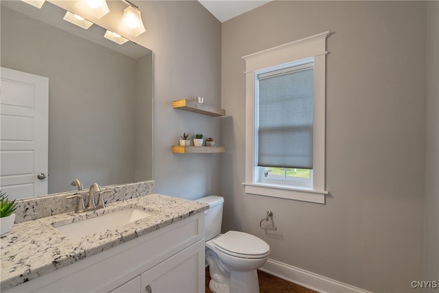 bathroom featuring vanity and toilet