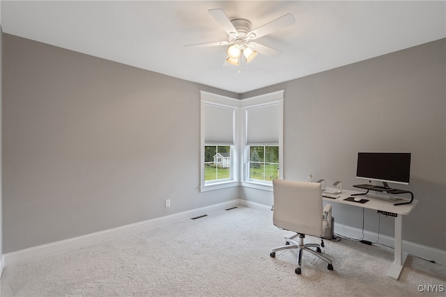 office space with ceiling fan and light carpet