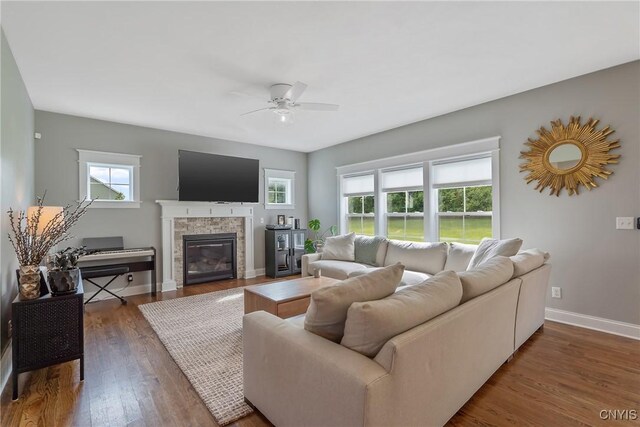 living room featuring ceiling fan and dark wood-type flooring