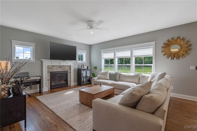 living room featuring ceiling fan and dark hardwood / wood-style floors