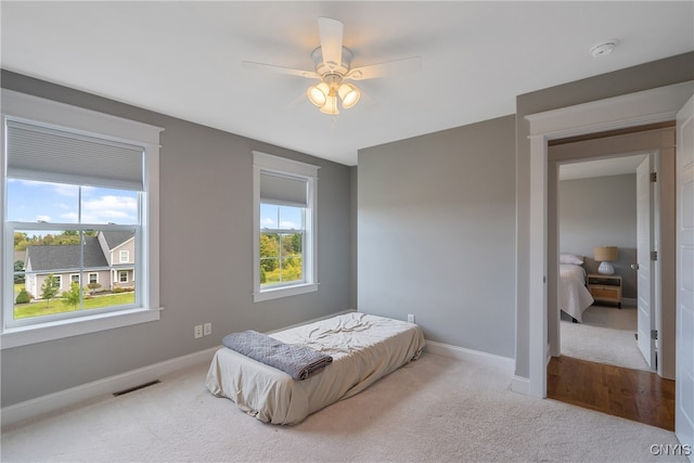 carpeted bedroom featuring ceiling fan