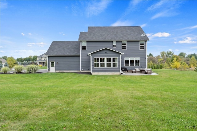 back of property with a lawn, a patio area, and an outdoor hangout area