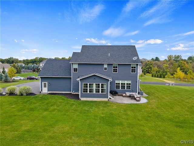 rear view of property with outdoor lounge area, a patio area, and a yard