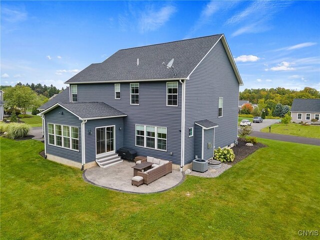 rear view of property featuring an outdoor living space, a patio area, a yard, and central AC