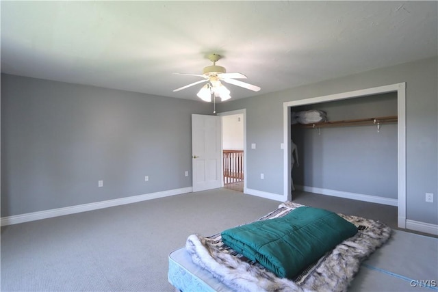 carpeted bedroom featuring ceiling fan and a closet