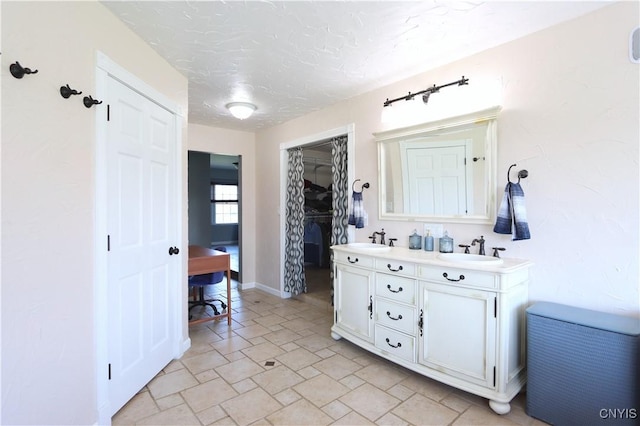 bathroom with vanity and a textured ceiling