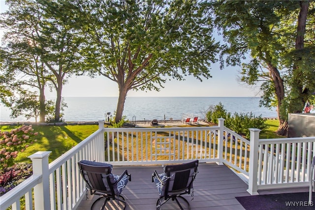 deck featuring a lawn and a water view