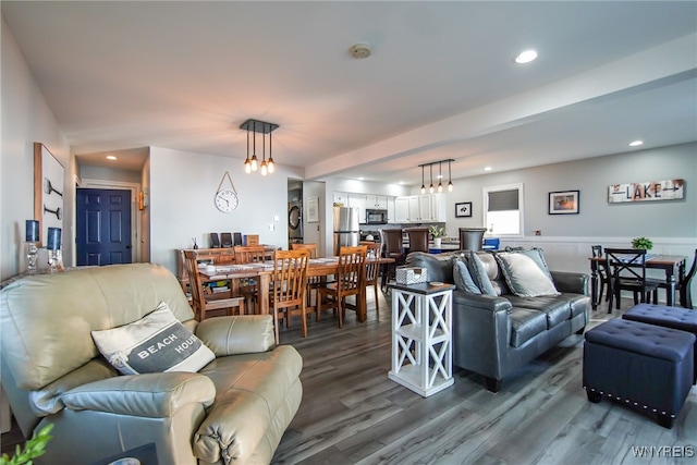 living room featuring a notable chandelier and hardwood / wood-style floors