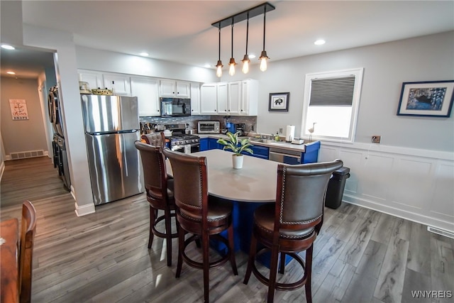 dining room with hardwood / wood-style floors