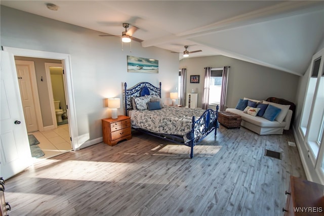 bedroom featuring ceiling fan, vaulted ceiling with beams, and light wood-type flooring