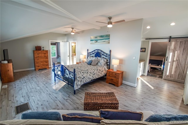 bedroom with lofted ceiling with beams, light wood-type flooring, ceiling fan, and a barn door