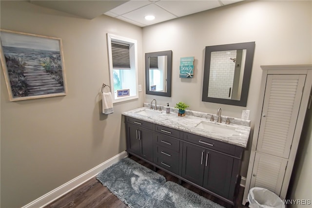 bathroom with hardwood / wood-style flooring, vanity, and a shower