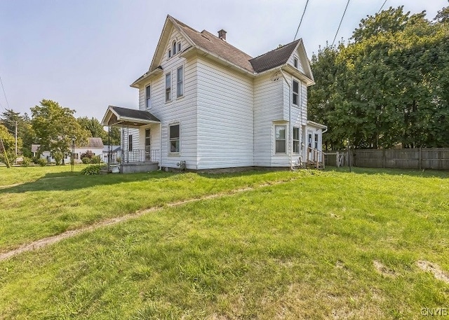 view of side of property with a lawn