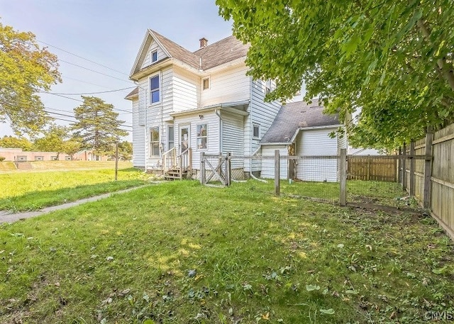 back of house with a yard