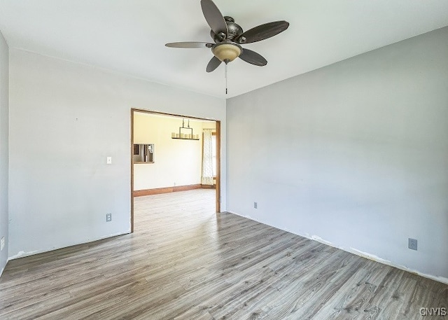 unfurnished room featuring light wood-type flooring and ceiling fan