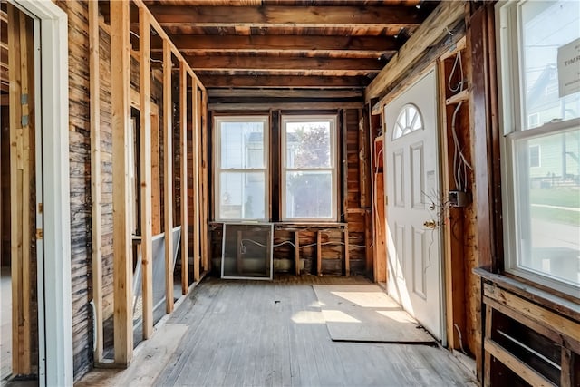 misc room with beam ceiling and hardwood / wood-style floors