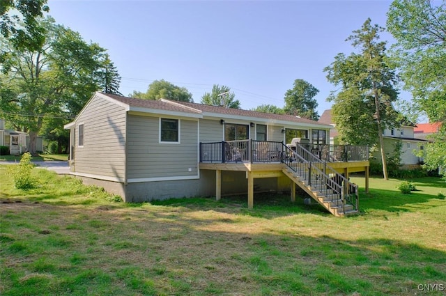 61 High St, Alexandria, NY 13607 - back of property featuring stairs, a wooden deck, and a lawn