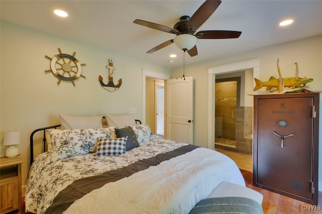 bedroom featuring light hardwood / wood-style floors, ceiling fan, and ensuite bath