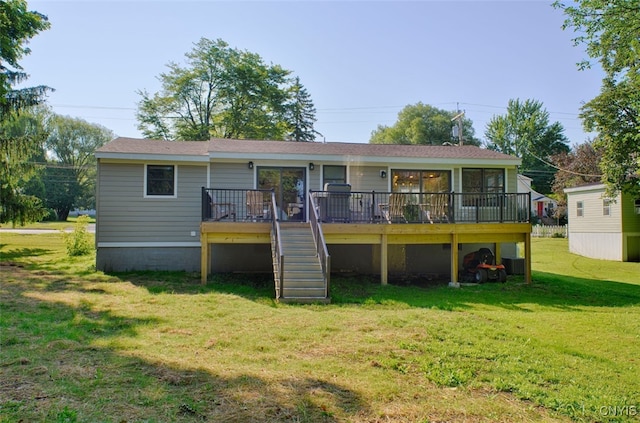 back of house featuring a deck and a yard