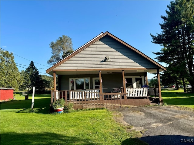 bungalow-style house with a front yard and a porch