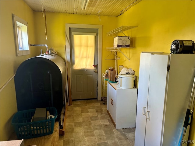 clothes washing area featuring wood ceiling