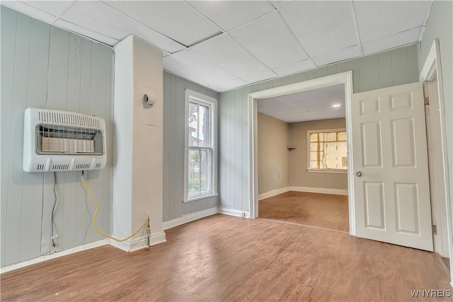 entryway featuring a drop ceiling, heating unit, and hardwood / wood-style flooring