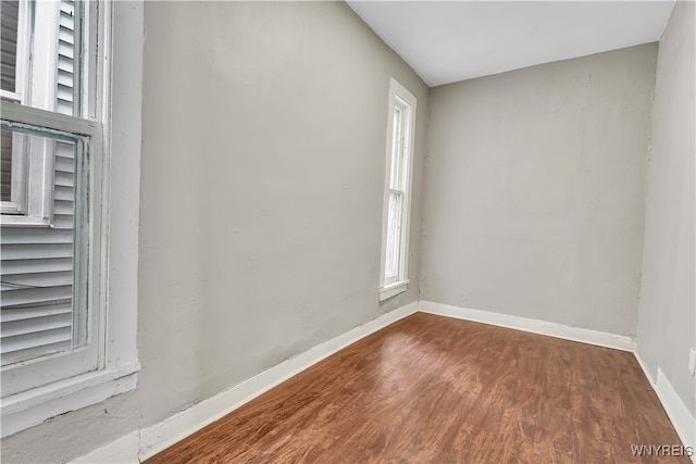 unfurnished room featuring hardwood / wood-style flooring and a wealth of natural light