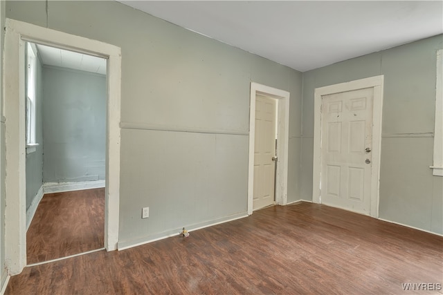 empty room with dark hardwood / wood-style flooring