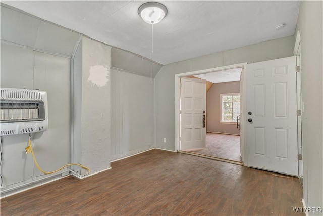 interior space featuring heating unit and dark wood-type flooring