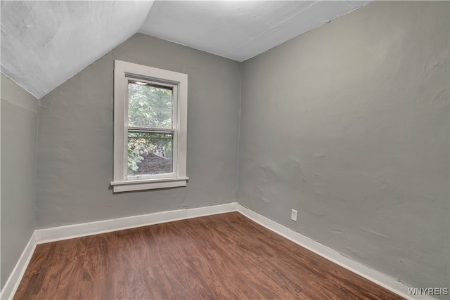 bonus room featuring dark hardwood / wood-style floors and vaulted ceiling