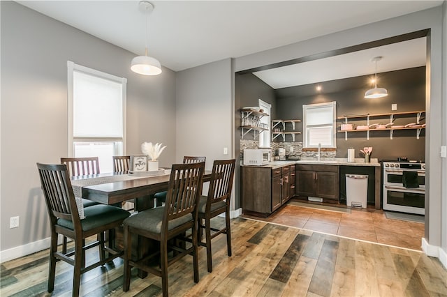 dining area with sink and light hardwood / wood-style flooring