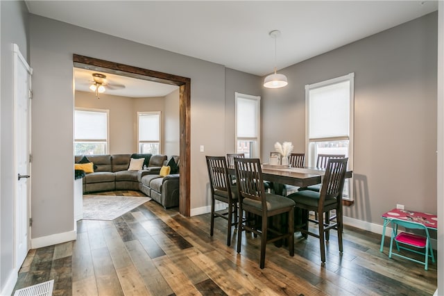 dining room with ceiling fan and dark hardwood / wood-style floors