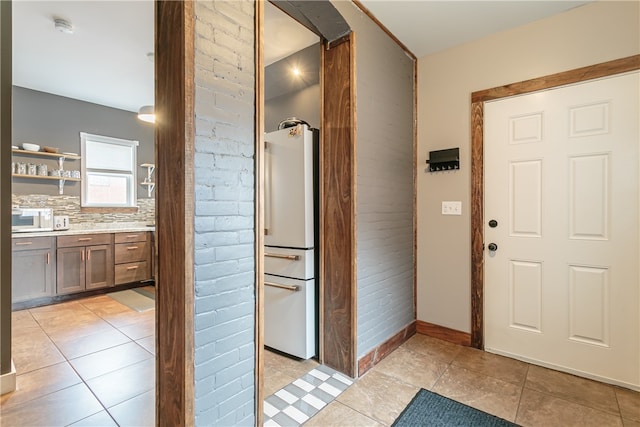 foyer entrance featuring light tile patterned floors