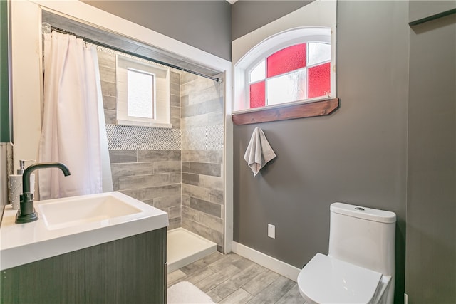 bathroom featuring walk in shower, vanity, toilet, and hardwood / wood-style flooring