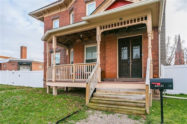 exterior space with a lawn and covered porch