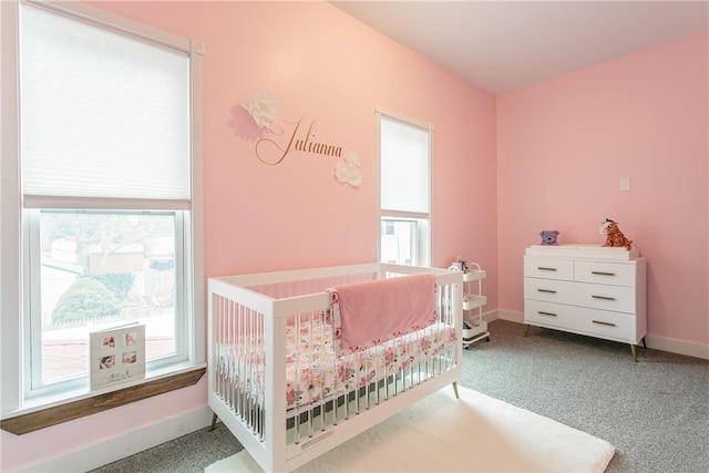 carpeted bedroom with a nursery area