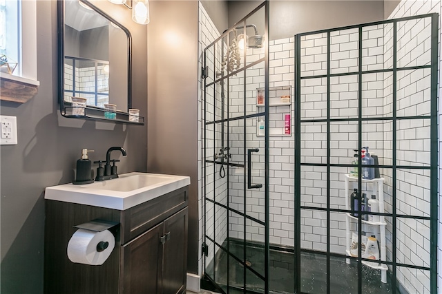 bathroom with vanity and tiled shower