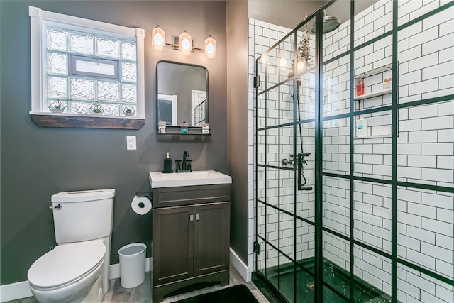 bathroom featuring an enclosed shower, vanity, and toilet