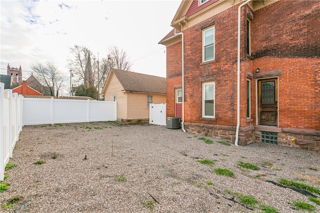 rear view of house featuring central AC unit