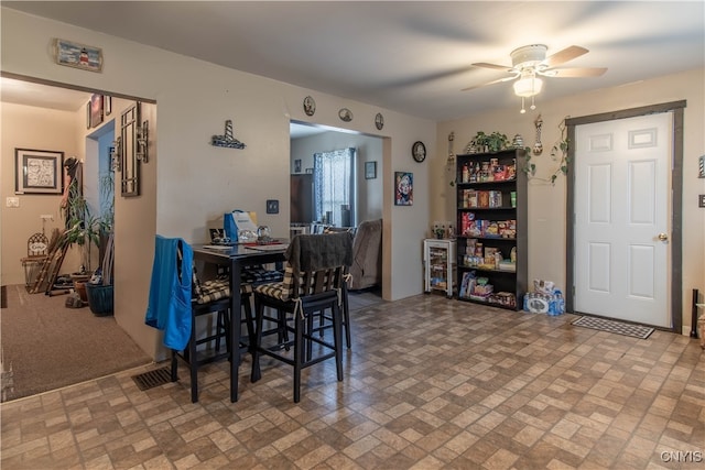 dining space featuring ceiling fan